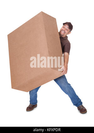 Delivery Man Carrying Heavy Box On White Background Stock Photo