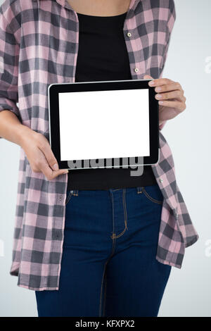 Mid section of female architect showing digital tablet against white background Stock Photo