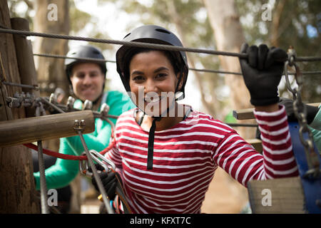 Portrait of woman on zipline in adventure park Stock Photo