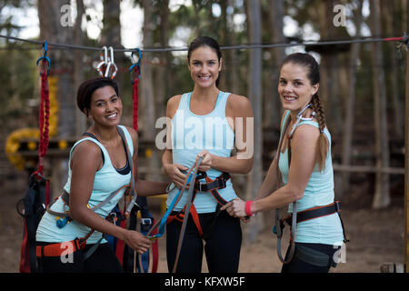 Portrait of happy female friends standing together in park Stock Photo