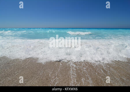 game of turquoise waves in a windy day on Lefkada island, Kathisma beach, Greece Stock Photo