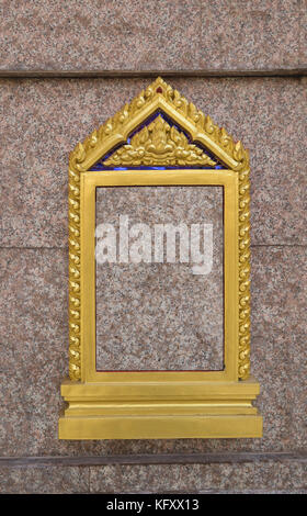 Traditional Thai grave banner on granite wall Stock Photo