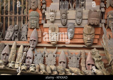 Traditional balinese wooden masks outside a shop in Ubud, Bali - Indonesia Stock Photo