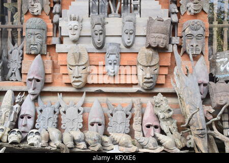 Traditional balinese wooden masks outside a shop in Ubud, Bali - Indonesia Stock Photo