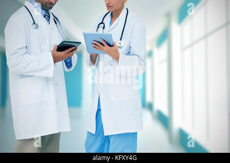 Doctors discussing something on clipboard against modern blue and white room Stock Photo