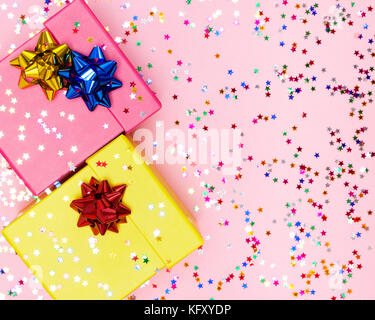 Celebratory background with two color gift boxes, wrap bows and confetti Stock Photo