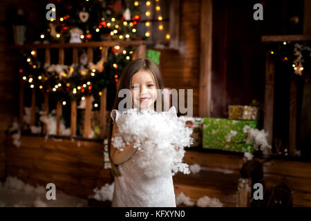 Merry Christmas and Happy Holidays. little girl in christmas decor Stock Photo