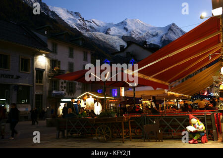 Chamonix street restaurants,Mont Blanc in back,  evenings, fall, French alps, France Stock Photo