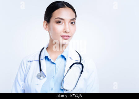 Pleasant woman in medical uniform wearing stethoscope Stock Photo
