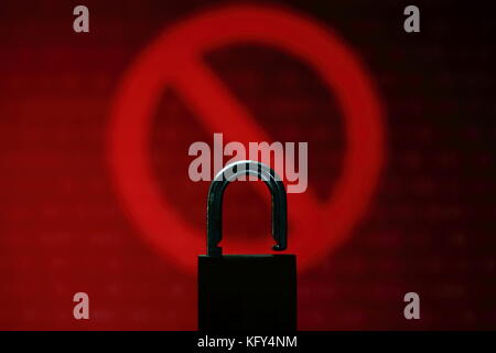 Visus or hacked computer screen   Red binary computer code ransom screen background with stop symbol sign. Stock Photo