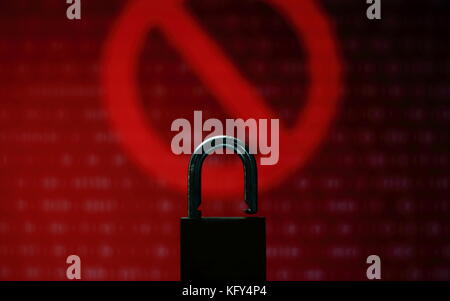 Visus or hacked computer screen   Red binary computer code ransom screen background with stop symbol sign. Stock Photo