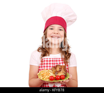 Happy little girl cook with roasted chicken wings on plate Stock Photo