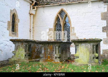 Tombs covered in algae in the 13th century Church of St Swithun at Compton Beauchamp in autumn. Vale of White Horse, Oxfordshire, England Stock Photo