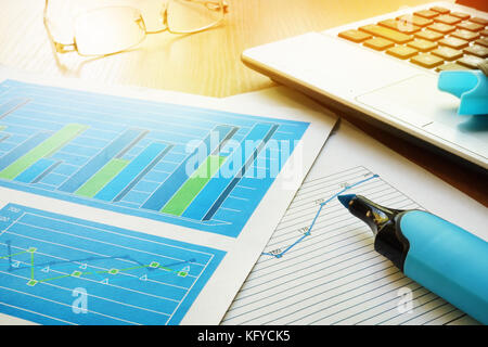 Business documents on an office desk and notebook. Stock Photo