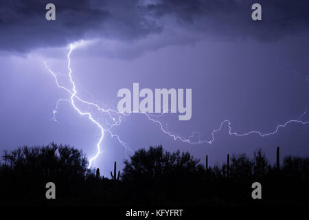 Lightning flashes in the sky from a thunderstorm in the Arizona desert Stock Photo