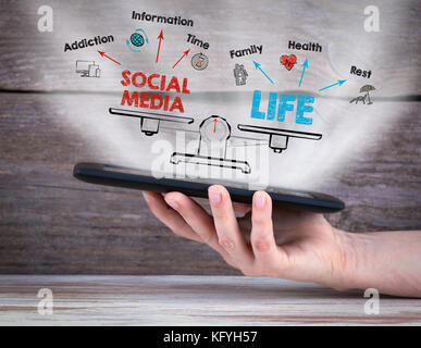 social media life balance. Chart with keywords and icons. Tablet computer in the hand Stock Photo
