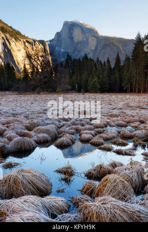 Famous icon of Yosemite National Park, Halfdome peak shot from Cook’s meadow with reflection and brown grass. Stock Photo