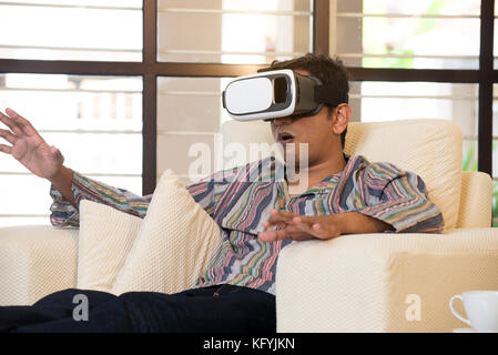 Indian male student studying in vr glasses Stock Photo