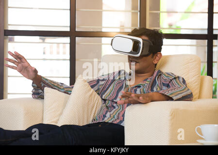 Indian male student studying in vr glasses Stock Photo