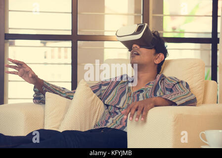 Indian male student studying in vr glasses Stock Photo