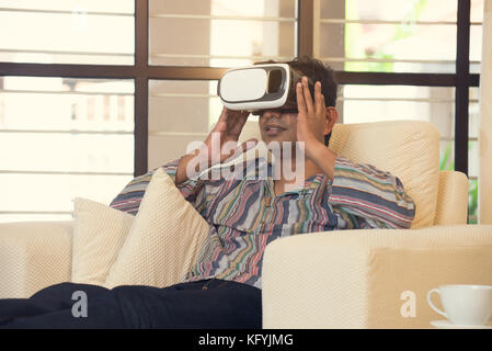 Indian male student studying in vr glasses Stock Photo