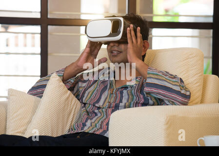 Indian male student studying in vr glasses Stock Photo