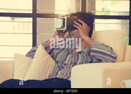 Indian male student studying in vr glasses Stock Photo