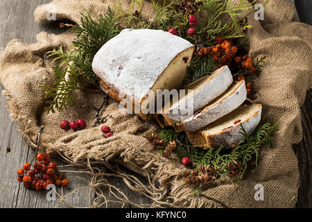 stollen on a wooden table, wrapped in burlap Stock Photo