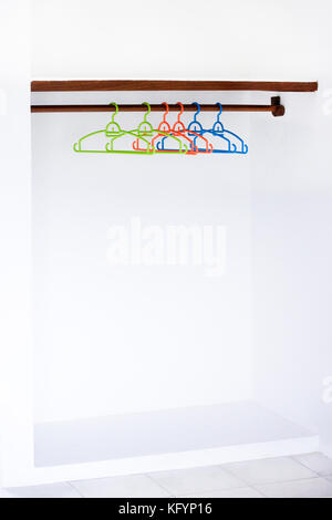 Nothing To Wear Design Sale Concept Wooden Coat Hanger on White Wall Copy Space. Empty wardrobe Stock Photo