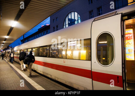 People walk and wait with train running in terminal for send and receive passengers at Mannheim Hauptbahnhof railway station on September 5, 2017 in M Stock Photo