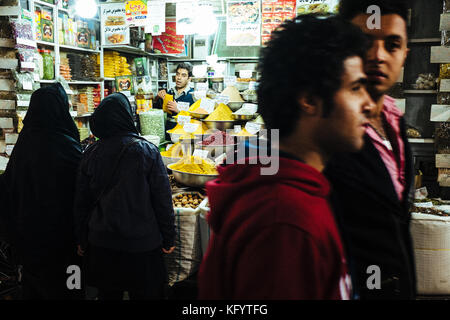 Shiraz, Iran - December 18, 2013. A local man is selling spices and other food products in a bazaar in Shiraz. Stock Photo