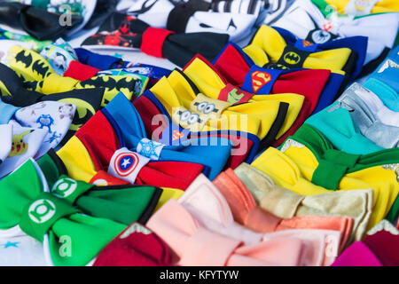 Close up image of set of colorful bow ties with superhero emblems in shop Stock Photo
