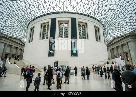 London, England - October 24, 2016. Museum guests seen in the reading room with its Great Court roof inside the British Museum in London.