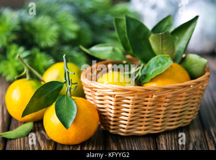 fresh tangerines with christmas decoration on a table Stock Photo