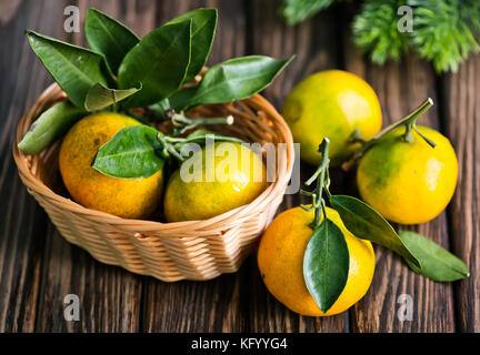 fresh tangerines with christmas decoration on a table Stock Photo
