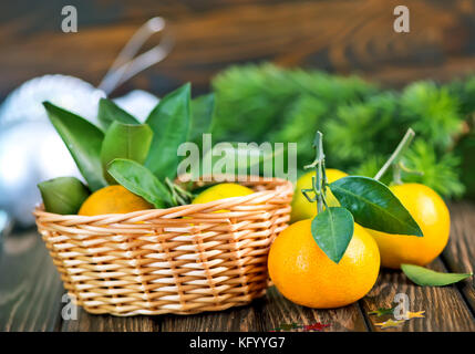 fresh tangerines with christmas decoration on a table Stock Photo