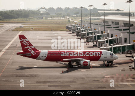 An AirAsia Bhd. A320 aircraft stands on the tarmac at Kuala Lumpur International Airport 2 (KLIA2) in Sepang, Selangor, Malaysia Stock Photo