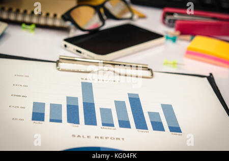 business report and chart on table. Stock Photo