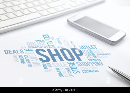Shop concept word cloud print document, keyboard, pen and smartphone. Stock Photo