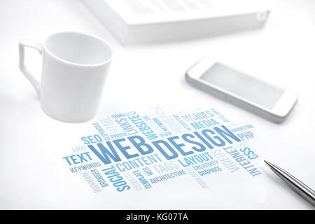 Web Design business concept word cloud print document, smartphone, book, pen and coffee cup. Blue toned. Stock Photo