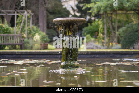 Statue and fountain in King George V Memorial Garden, Bath. Feature in Henrietta park in Somerset, UK, with algae covering detail of female figures Stock Photo