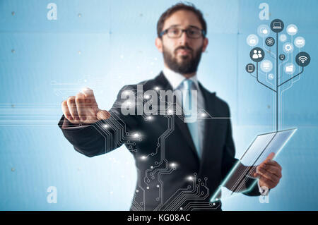 Businessman standing and working with touch screen technology Stock Photo