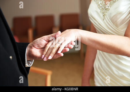 Couple exchange wedding rings on their wedding day Stock Photo