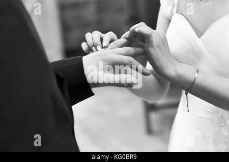 Couple exchange wedding rings on their wedding day Stock Photo