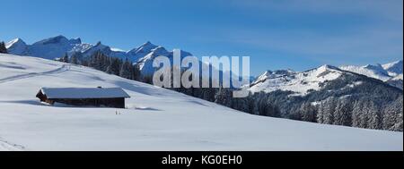 Winter day in the Bernese Oberland. Snow covered mountains. Landscape near Gstaad. Stock Photo