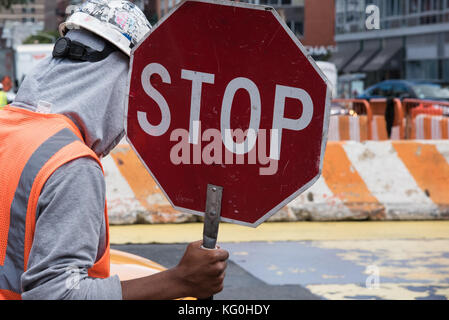 A worker carrying stop sign Stock Photo