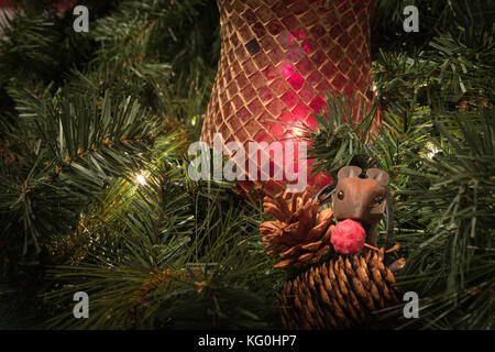 Christmas greenery display with red candle holder, pine cones and little wooden mouse Stock Photo