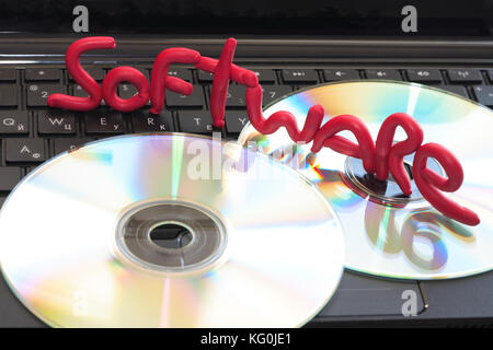Word SOFTWARE made from red plasticine standing on CD on black computer keyboard Stock Photo