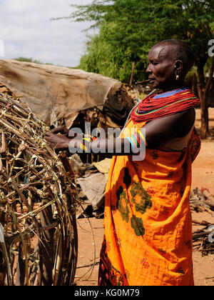 SOUTH HORR, KENYA - JULY 07: African woman from the Samburu tribe in the traditional dress he is building his house in Kenya, South Horr in July 07, 2 Stock Photo