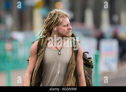 Young man with dreadlocks walking in the UK. Stock Photo